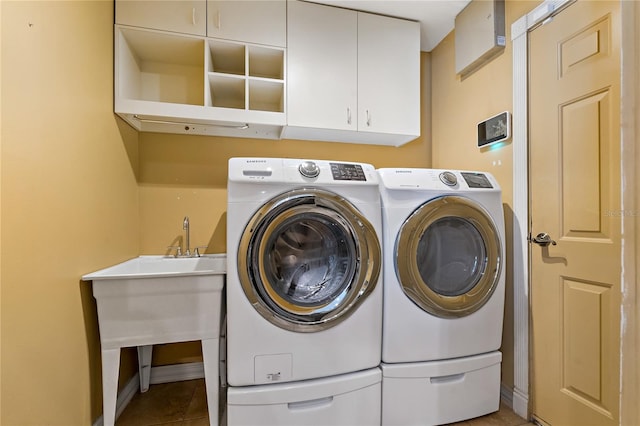 1046 Middlesex Dr, New Port Richey, FL 34655 - washroom featuring cabinet space, washing machine and dryer, and tile patterned floors