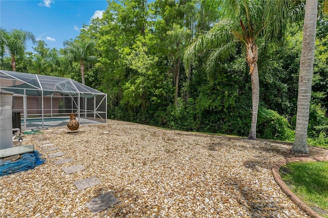 1046 Middlesex Dr, New Port Richey, FL 34655 - view of yard featuring an outdoor pool and glass enclosure