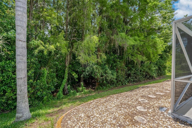 1046 Middlesex Dr, New Port Richey, FL 34655 - view of yard featuring glass enclosure