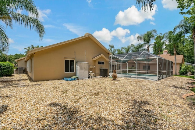 1046 Middlesex Dr, New Port Richey, FL 34655 - rear view of property featuring stucco siding, an outdoor pool, and a lanai