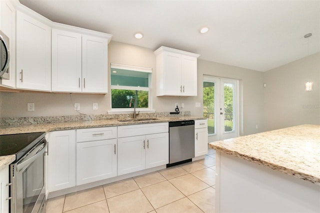 13116 Marathon Blvd, Port Charlotte, FL 33981 - kitchen with appliances with stainless steel finishes, white cabinets, light tile patterned floors, light stone counters, and recessed lighting