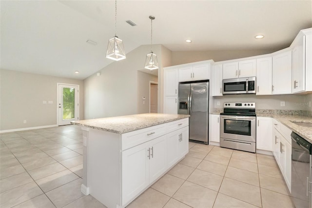 13116 Marathon Blvd, Port Charlotte, FL 33981 - kitchen with appliances with stainless steel finishes, lofted ceiling, a center island, light tile patterned floors, and light stone countertops