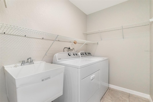 13116 Marathon Blvd, Port Charlotte, FL 33981 - laundry area with separate washer and dryer and light tile patterned flooring