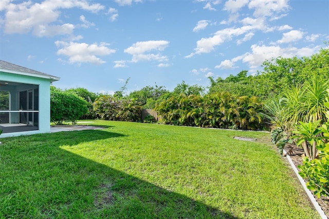 13116 Marathon Blvd, Port Charlotte, FL 33981 - view of green lawn featuring a sunroom and a patio area