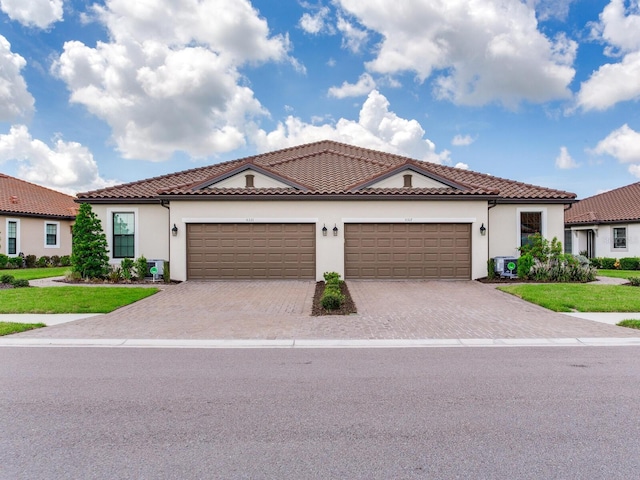 5317 Rushmere Ct, Palmetto, FL 34221 - mediterranean / spanish-style home featuring stucco siding, driveway, and a garage
