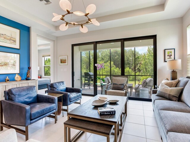 5317 Rushmere Ct, Palmetto, FL 34221 - living area featuring a raised ceiling, a chandelier, and light tile patterned flooring