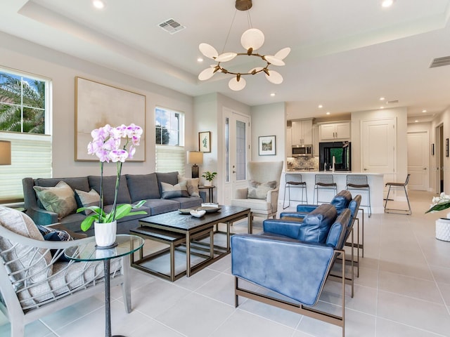 5317 Rushmere Ct, Palmetto, FL 34221 - living area with a raised ceiling, a chandelier, plenty of natural light, light tile patterned floors, and recessed lighting