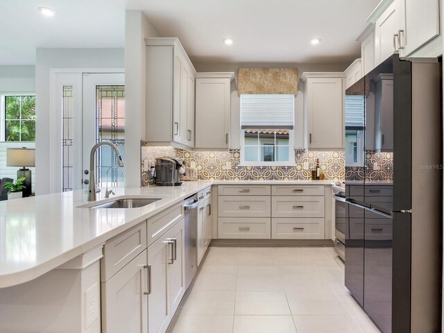5317 Rushmere Ct, Palmetto, FL 34221 - kitchen featuring stainless steel appliances, light countertops, tasteful backsplash, recessed lighting, and white cabinetry