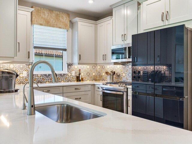 5317 Rushmere Ct, Palmetto, FL 34221 - kitchen with appliances with stainless steel finishes, light countertops, decorative backsplash, and recessed lighting