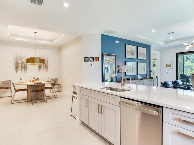 5317 Rushmere Ct, Palmetto, FL 34221 - kitchen featuring dishwasher, a raised ceiling, recessed lighting, light countertops, and white cabinetry