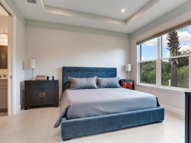 5317 Rushmere Ct, Palmetto, FL 34221 - bedroom featuring a tray ceiling, light tile patterned floors, ensuite bath, and recessed lighting