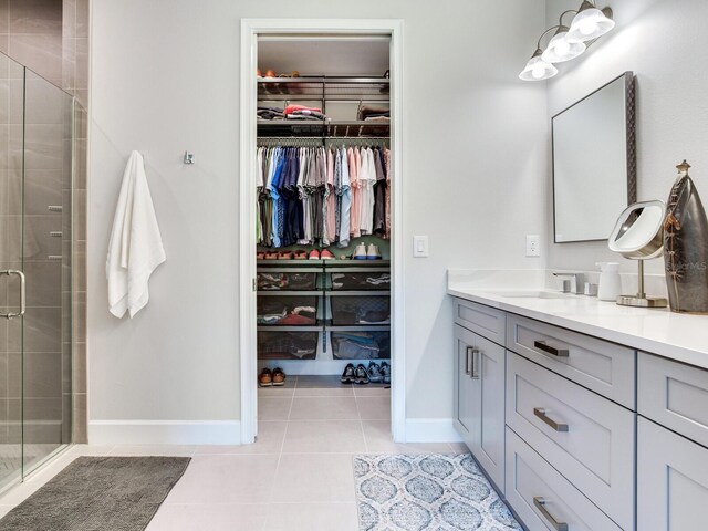 5317 Rushmere Ct, Palmetto, FL 34221 - bathroom with vanity, a spacious closet, tile patterned flooring, and a shower stall