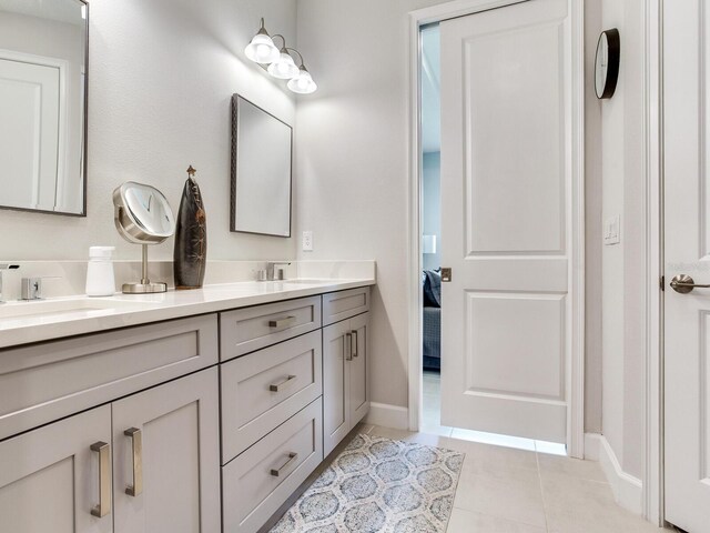 5317 Rushmere Ct, Palmetto, FL 34221 - ensuite bathroom featuring double vanity and tile patterned flooring