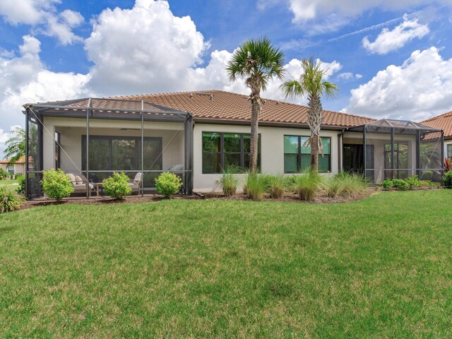 5317 Rushmere Ct, Palmetto, FL 34221 - back of house featuring stucco siding, a tile roof, a yard, and glass enclosure