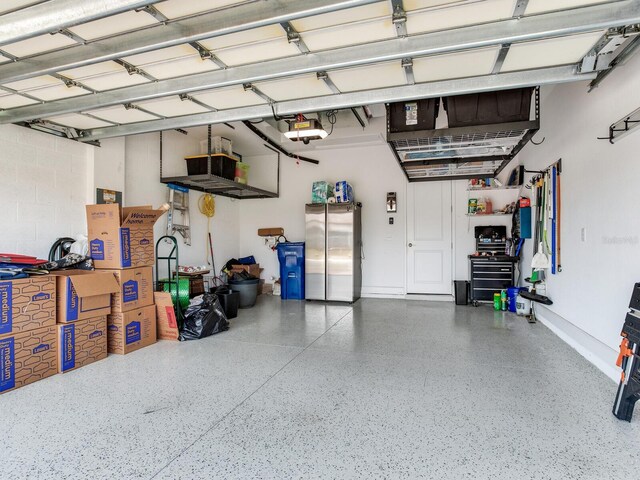 5317 Rushmere Ct, Palmetto, FL 34221 - garage with freestanding refrigerator and a garage door opener