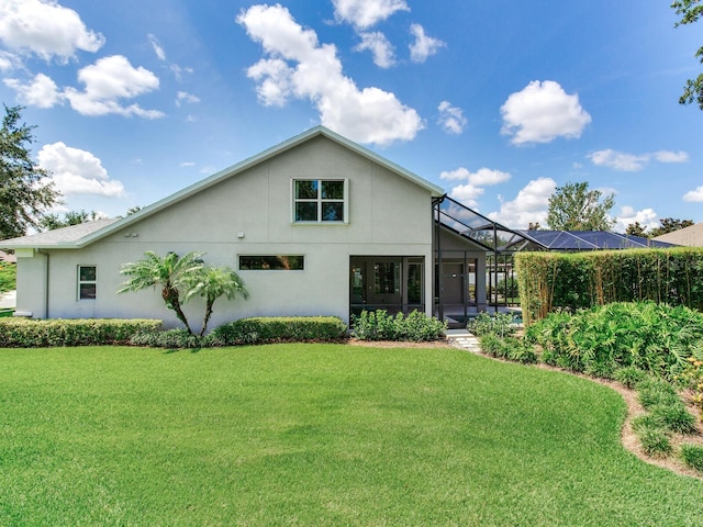 3503 Graycliff Ln, Brandon, FL 33511 - back of property featuring stucco siding, a lawn, and glass enclosure