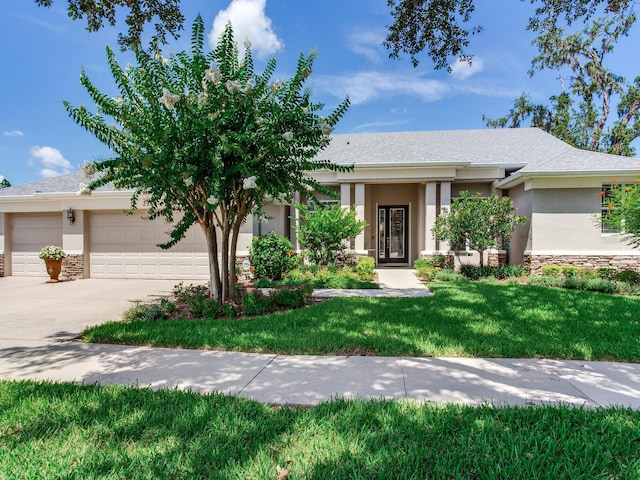 3503 Graycliff Ln, Brandon, FL 33511 - view of front of house with a garage, driveway, stucco siding, stone siding, and a front yard