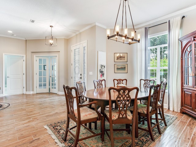 3503 Graycliff Ln, Brandon, FL 33511 - dining area with light wood-type flooring, crown molding, a chandelier, and recessed lighting
