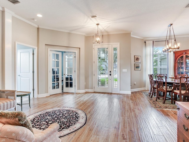 3503 Graycliff Ln, Brandon, FL 33511 - living area featuring a chandelier, light wood-type flooring, and crown molding