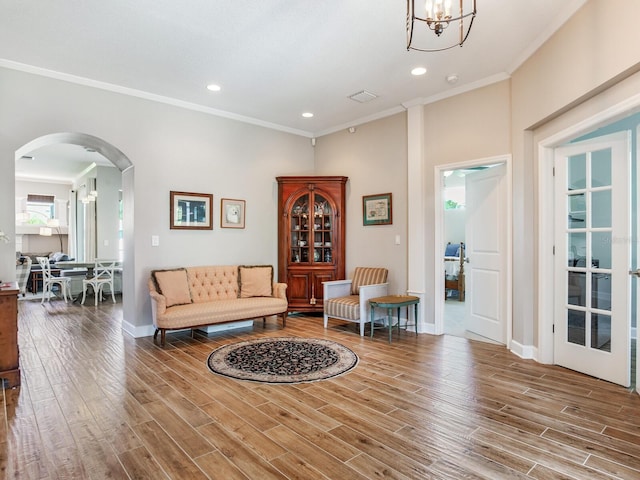 3503 Graycliff Ln, Brandon, FL 33511 - living area with arched walkways, wood finished floors, crown molding, recessed lighting, and a chandelier