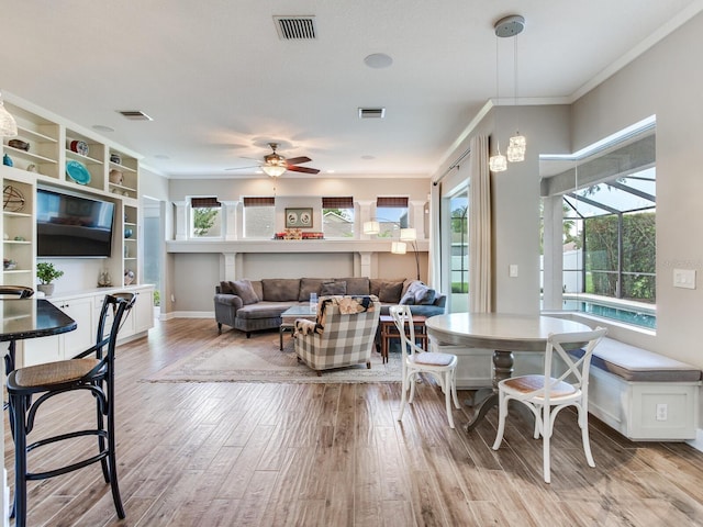 3503 Graycliff Ln, Brandon, FL 33511 - dining space featuring light wood-style flooring, ceiling fan, and ornamental molding