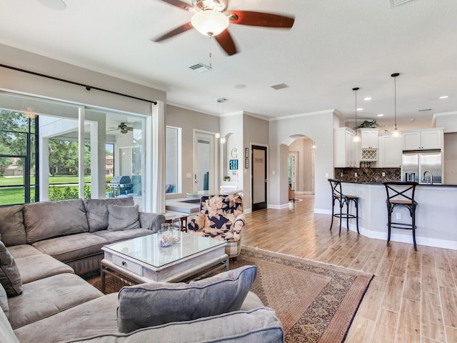 3503 Graycliff Ln, Brandon, FL 33511 - living room with ceiling fan, arched walkways, ornamental molding, light wood-type flooring, and recessed lighting