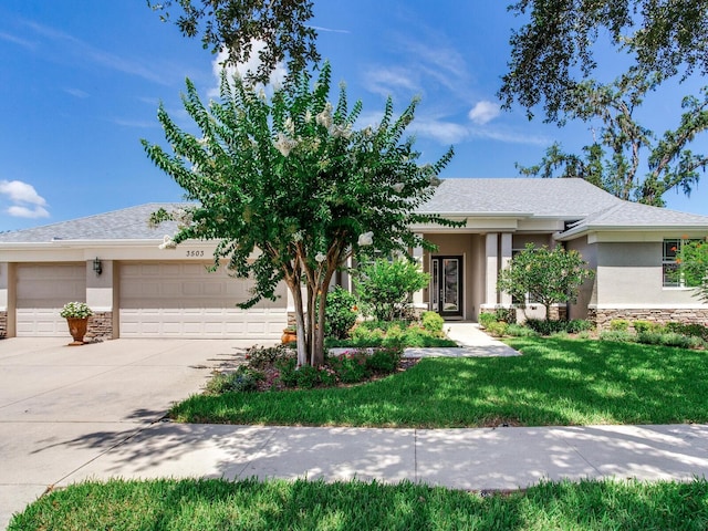 3503 Graycliff Ln, Brandon, FL 33511 - view of front facade with an attached garage, stucco siding, stone siding, and driveway