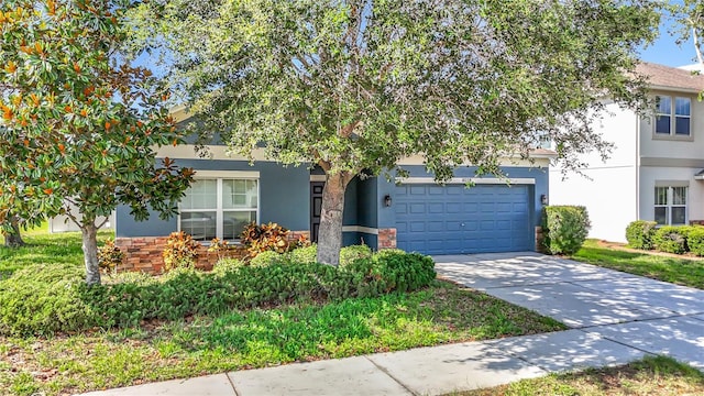 18339 Fish Loop, Land O Lakes, FL 34638 - view of property hidden behind natural elements with stucco siding, driveway, and an attached garage