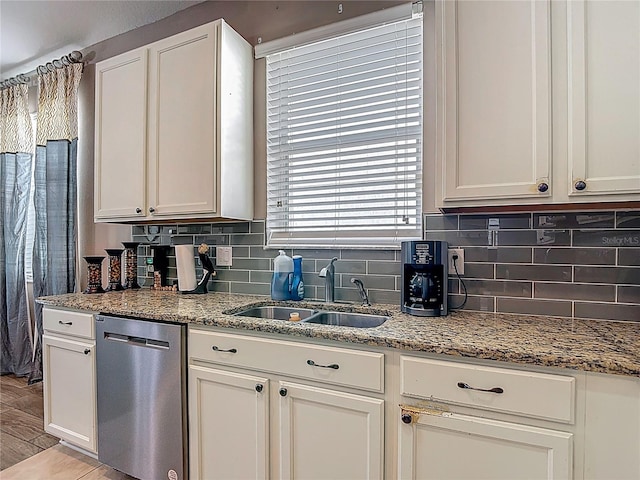 18339 Fish Loop, Land O Lakes, FL 34638 - kitchen featuring stainless steel dishwasher, backsplash, light stone countertops, and white cabinetry