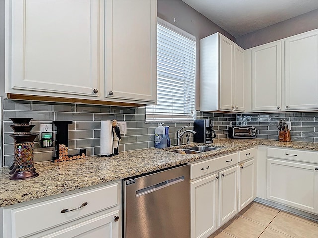 18339 Fish Loop, Land O Lakes, FL 34638 - kitchen with dishwasher, tasteful backsplash, light stone countertops, and white cabinetry