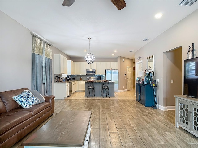 18339 Fish Loop, Land O Lakes, FL 34638 - living area with wood finish floors, a ceiling fan, and recessed lighting