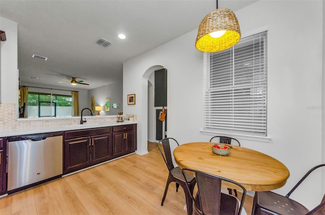 2119 Broadway View Ave, Brandon, FL 33510 - kitchen with stainless steel dishwasher, arched walkways, a ceiling fan, light countertops, and light wood-style floors