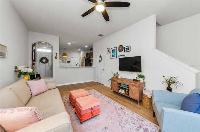 2119 Broadway View Ave, Brandon, FL 33510 - living area with a ceiling fan, light wood-style flooring, arched walkways, and recessed lighting