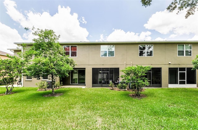 2119 Broadway View Ave, Brandon, FL 33510 - back of house featuring stucco siding and a yard