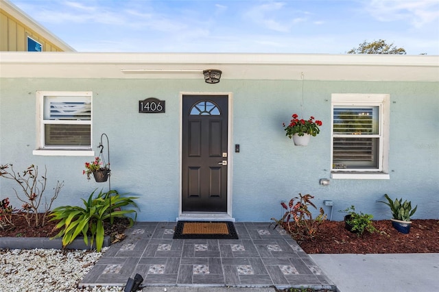 1406 Nebraska Ave, Palm Harbor, FL 34683 - doorway to property featuring stucco siding