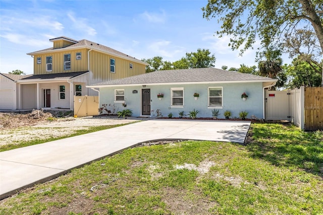 1406 Nebraska Ave, Palm Harbor, FL 34683 - view of front of home featuring a gate and board and batten siding