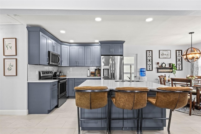 1406 Nebraska Ave, Palm Harbor, FL 34683 - kitchen with stainless steel appliances, light countertops, a kitchen bar, tasteful backsplash, and recessed lighting