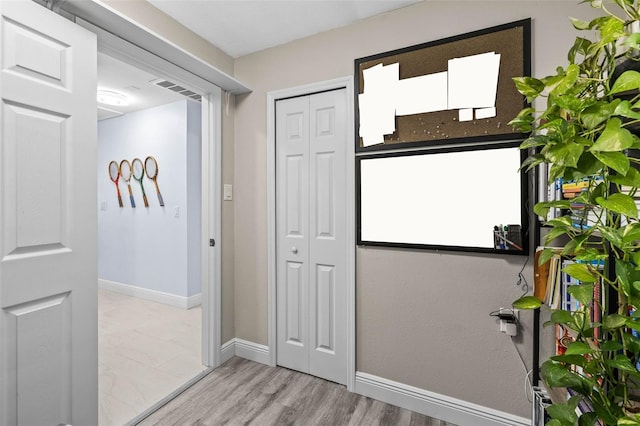 1406 Nebraska Ave, Palm Harbor, FL 34683 - doorway featuring baseboards and light wood finished floors