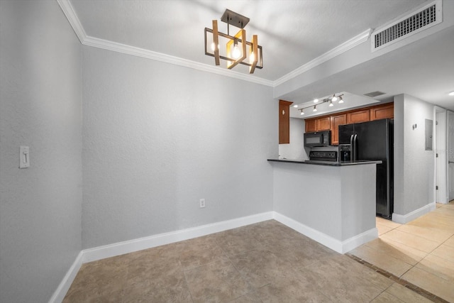 720 Lyndhurst St Unit 1101, Dunedin, FL 34698 - kitchen featuring black appliances, crown molding, brown cabinetry, dark countertops, and light tile patterned floors