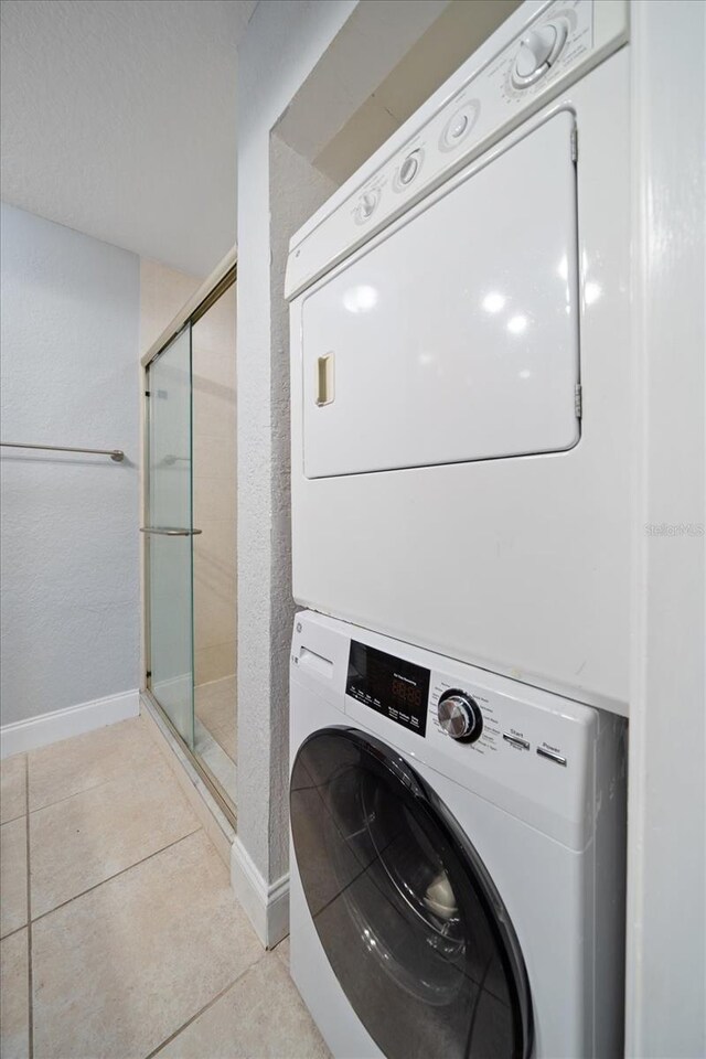720 Lyndhurst St Unit 1101, Dunedin, FL 34698 - laundry area with stacked washing machine and dryer and light tile patterned floors