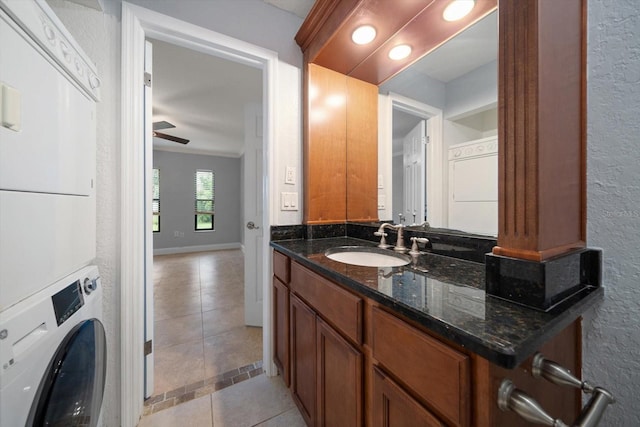 720 Lyndhurst St Unit 1101, Dunedin, FL 34698 - bathroom featuring stacked washer / drying machine, tile patterned floors, ceiling fan, vanity, and a textured wall