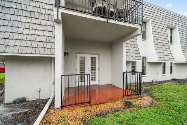 720 Lyndhurst St Unit 1101, Dunedin, FL 34698 - doorway to property featuring stucco siding and french doors