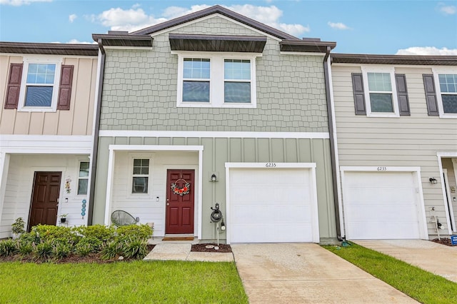 6235 Bucket Ct, Gibsonton, FL 33534 - townhome / multi-family property with concrete driveway, an attached garage, and board and batten siding