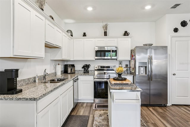 6235 Bucket Ct, Gibsonton, FL 33534 - kitchen featuring appliances with stainless steel finishes, dark wood-style floors, white cabinets, light stone counters, and recessed lighting