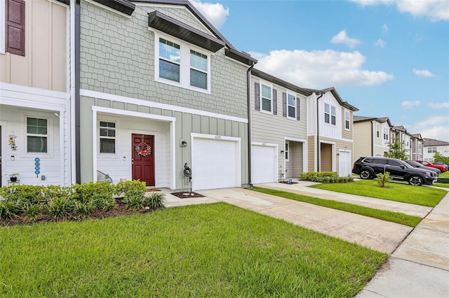 6235 Bucket Ct, Gibsonton, FL 33534 - townhome / multi-family property with driveway, board and batten siding, a residential view, and an attached garage