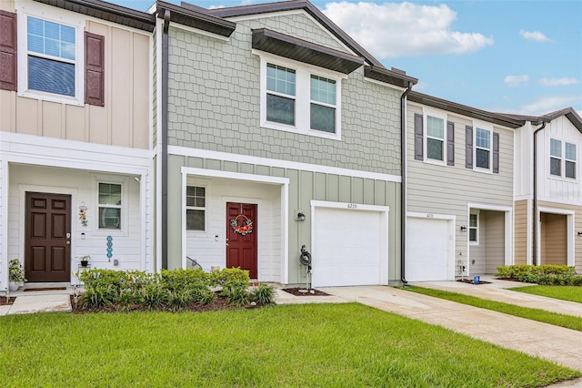 6235 Bucket Ct, Gibsonton, FL 33534 - multi unit property with driveway, board and batten siding, a front lawn, and a garage