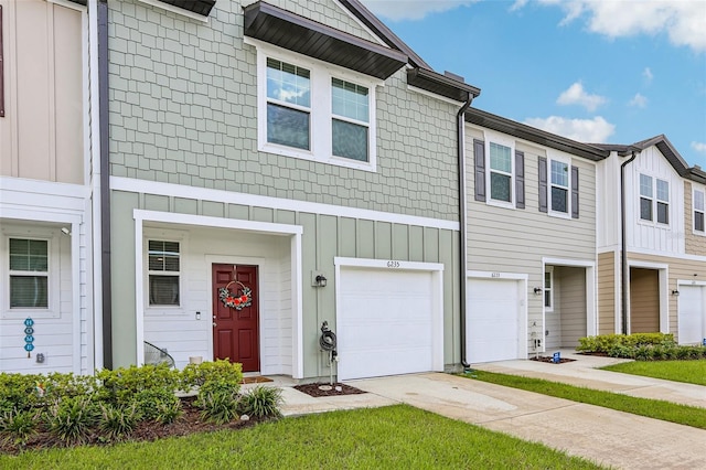 6235 Bucket Ct, Gibsonton, FL 33534 - view of property with driveway, board and batten siding, and an attached garage