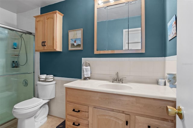 5660 80th St N Unit B106, Saint Petersburg, FL 33709 - bathroom with tile walls, vanity, a stall shower, and wainscoting