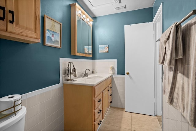 5660 80th St N Unit B106, Saint Petersburg, FL 33709 - bathroom with tile walls, vanity, tile patterned flooring, and a wainscoted wall