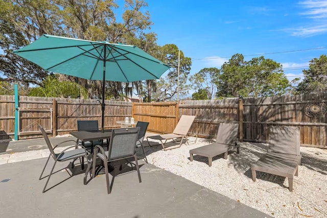 201 S St, Palm Harbor, FL 34683 - fenced backyard featuring a patio and outdoor dining area